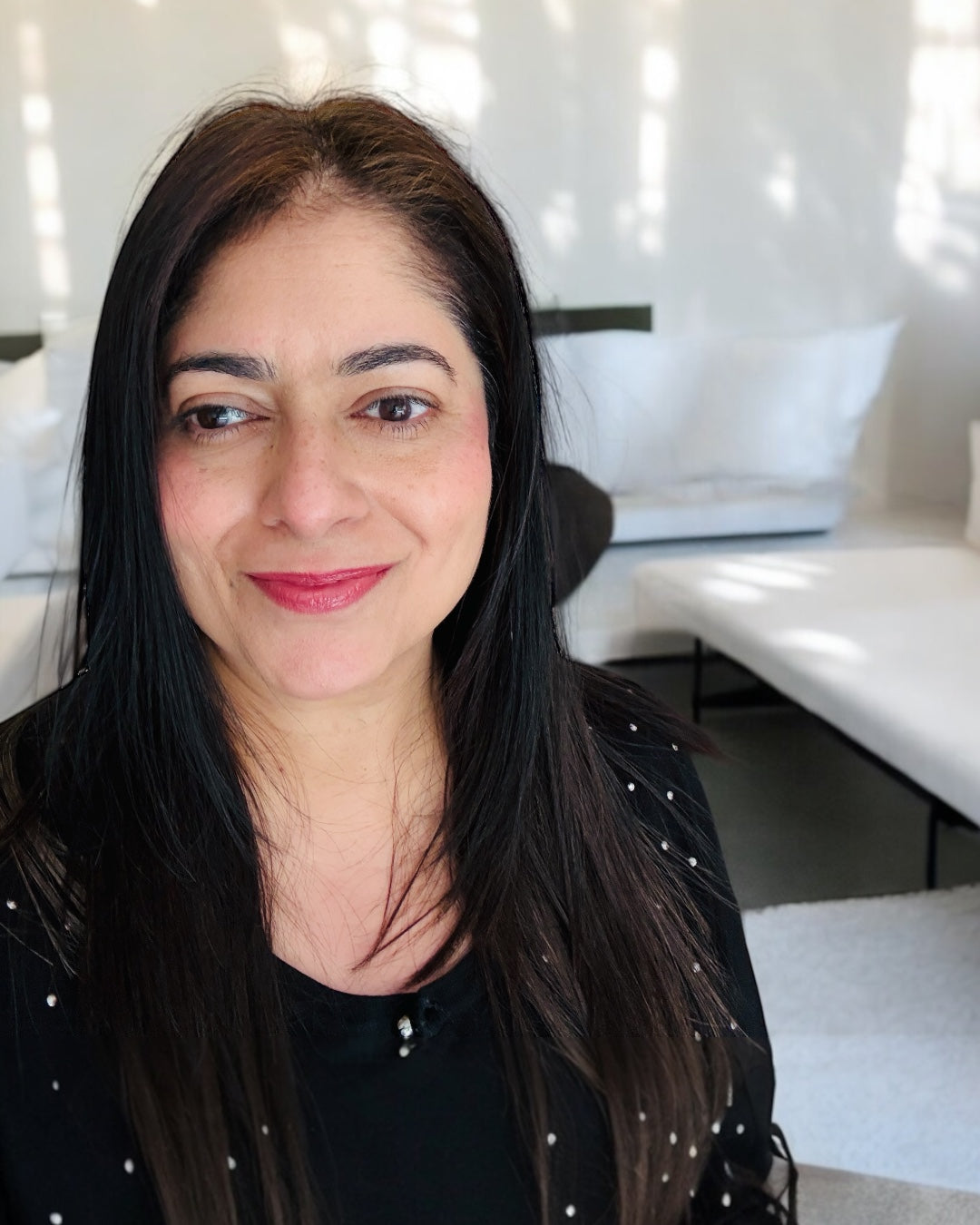Founder Arati in a living room with sunlight in the background
