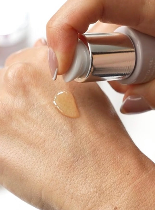 Hand dispensing a pump of Anara Replenishing Face Oil onto the hand, to show the texture of the oil