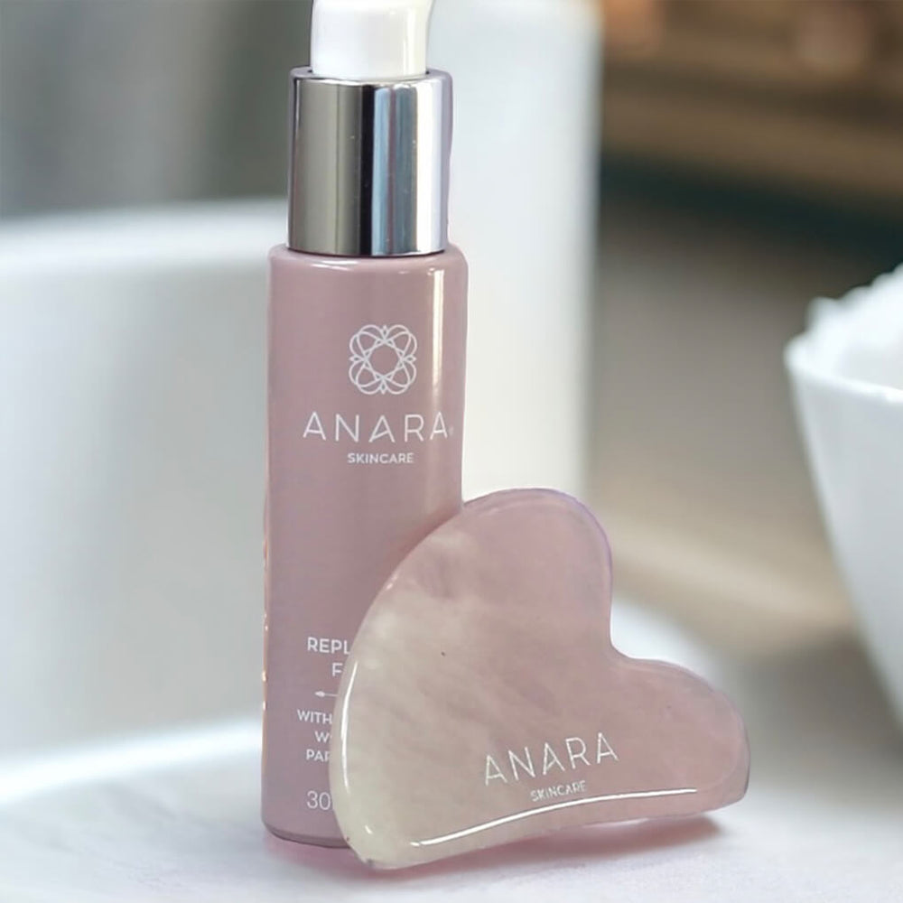 Anara Replenishing Face Oil with Rose Quartz Heart Shaped Gua Sha in a white bathroom