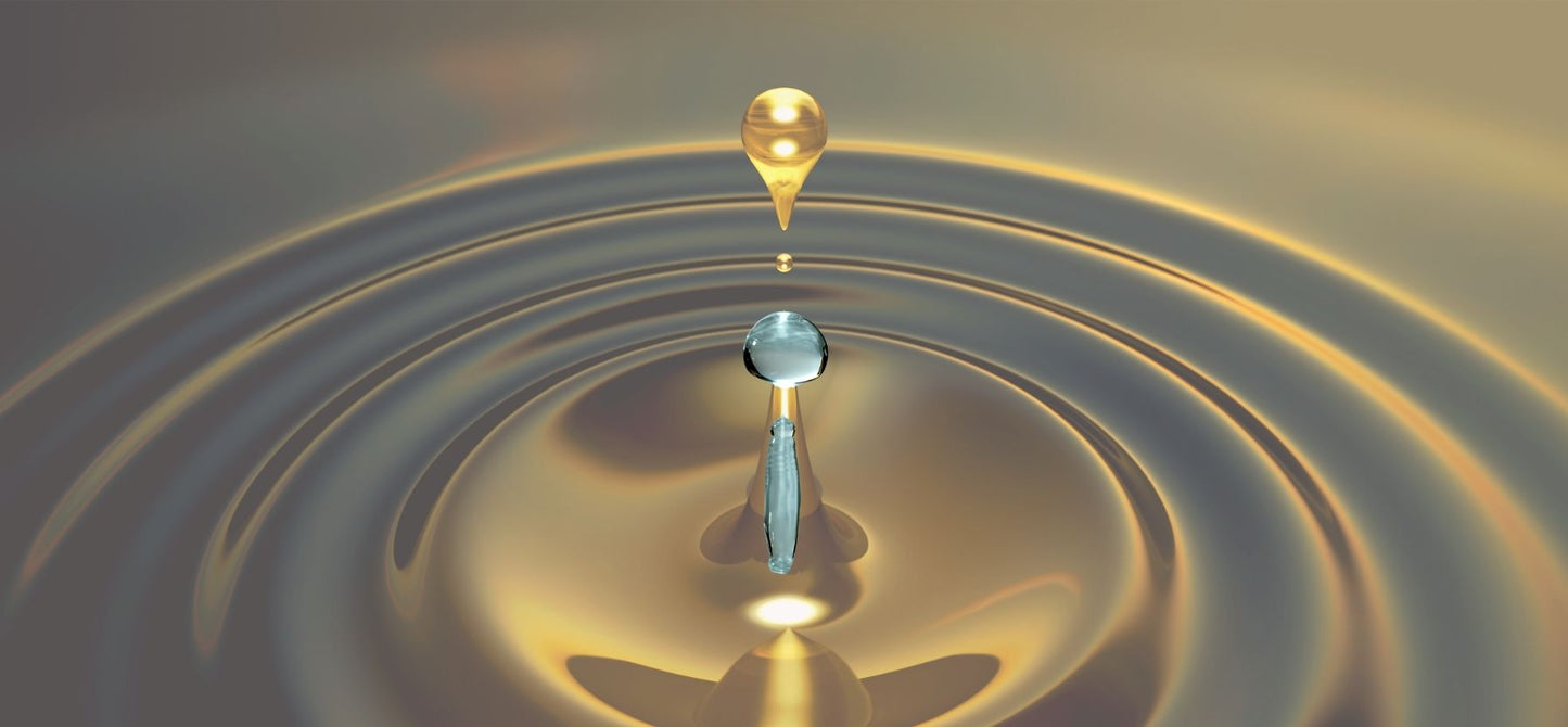 Oil and water droplets into a ripple of oil