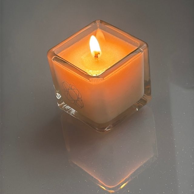 
                  
                    Anara Skincare square candle lit with reflection into the surface
                  
                