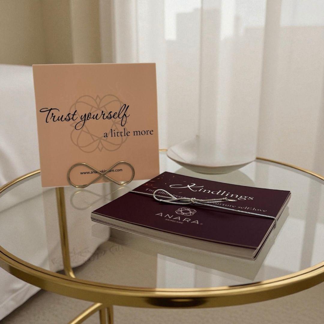Anara Skincare Kindling  with 'Trust yourself a little more' card on a glass table
