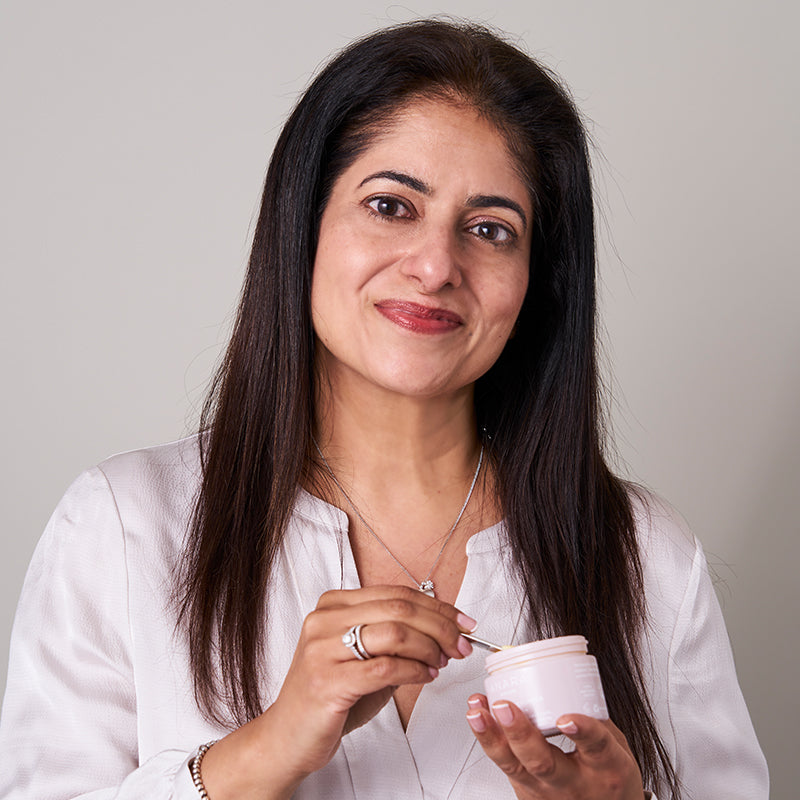 Arati, founder of Anara Skincare, holding a pot of Radiance Moisturiser