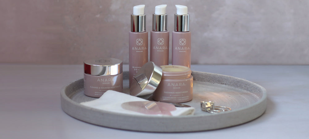 Anara Skincare product range in a lifetyle setting featuring a tray, face cloth and jewellery