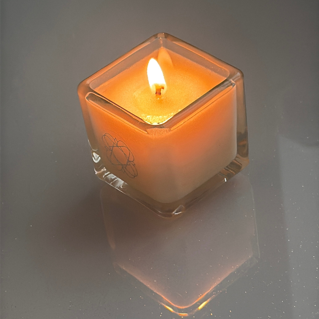 
                  
                    Anara Aromatherapy Candle lit on reflective grey surface
                  
                