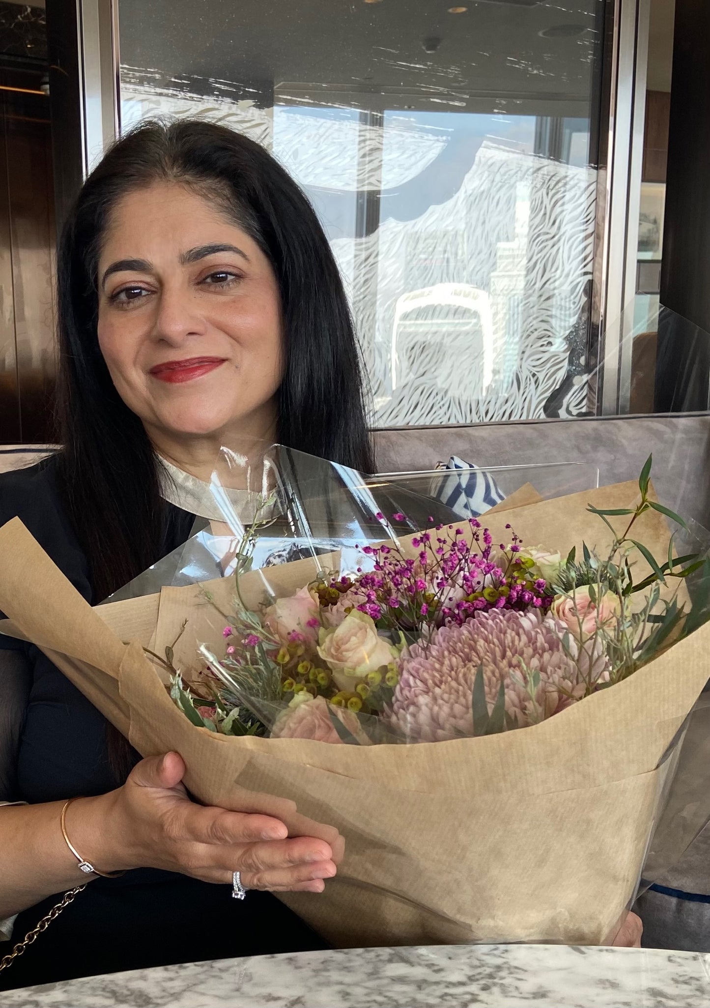 Arati receiving flowers at the Shangri-La at the Shard for Anara's first birthday