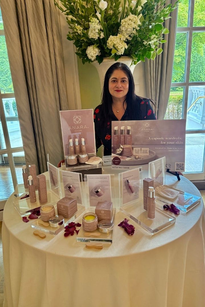 Founder Arati with the Anara range displayed on a round table with cream table cloth at the Mandarin Oriental Hotel