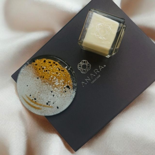 Anara Skincare square candle with round Eratini fused glass plate on gift box