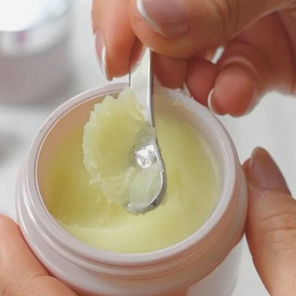 
                  
                    Anara Skincare Cleanse & Nourish Night Balm jar with some being scooped with a spatula
                  
                