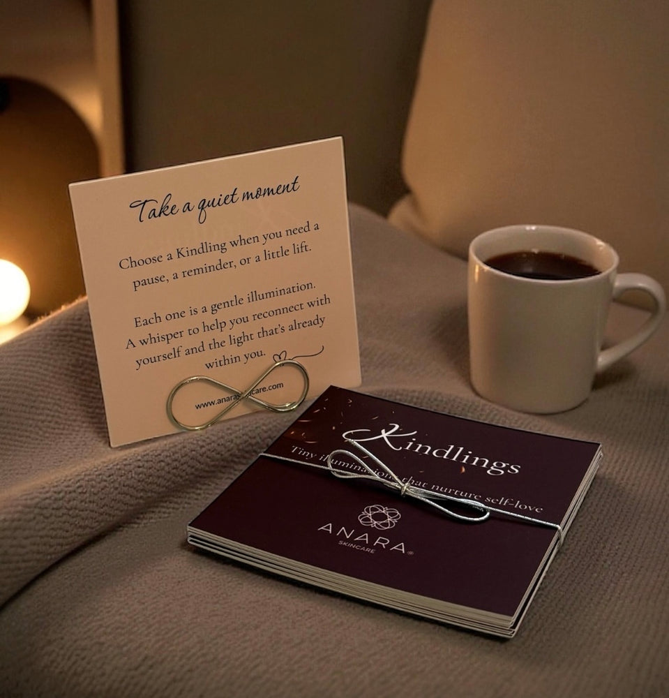 
                  
                    Anara Kindlings set with the intro in the metal infinity holder with a black coffee on a beige blanket
                  
                