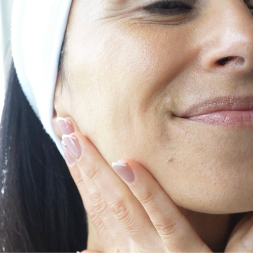 Lady with moisturiser on her cheek
