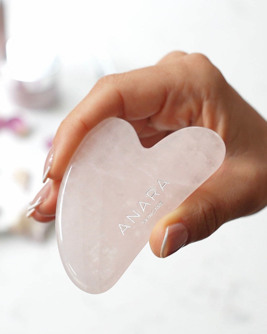 Anara Skincare Rose Quartz Gua Sha in hand