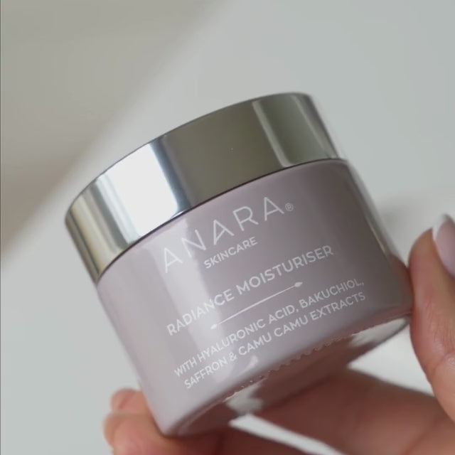 Lady with dark hair applying Anara Skincare Radiance Moisturiser on eyes and face