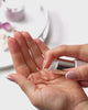 Lady applying Anara Replenishing Face Oil to skin