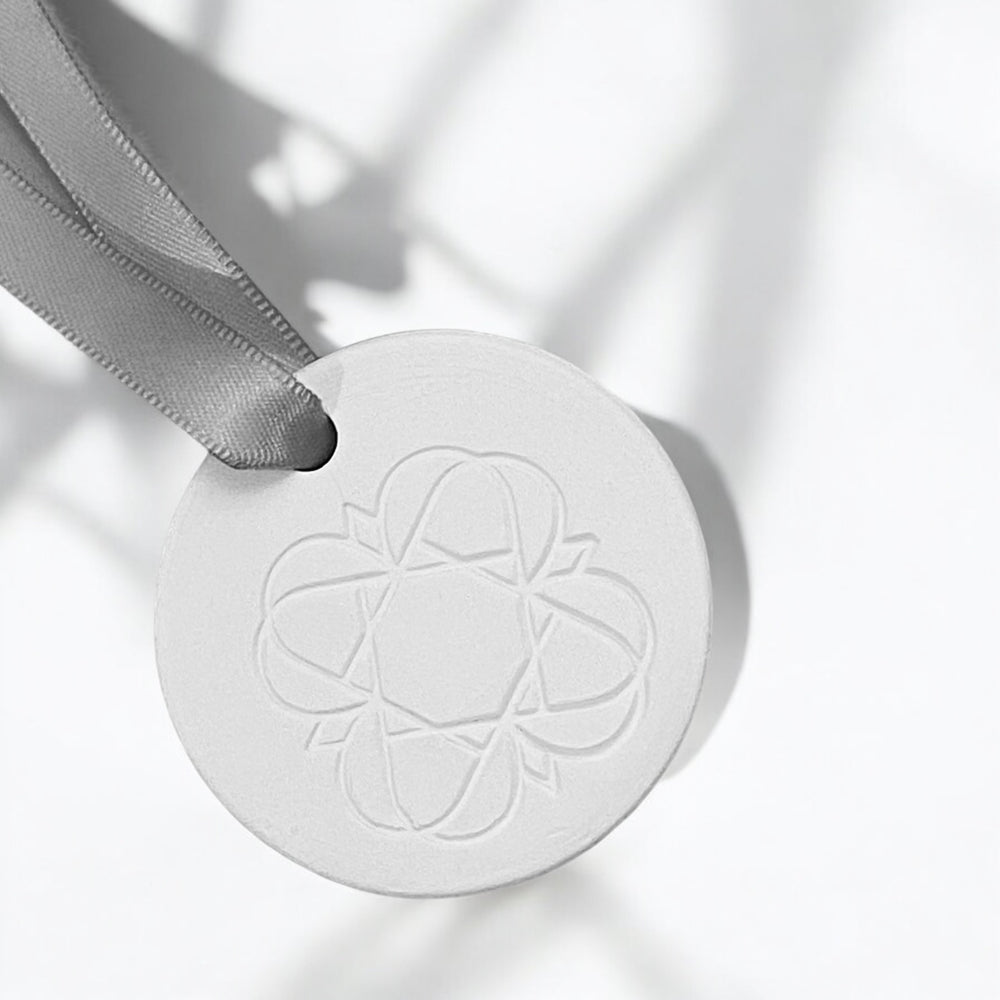 Anara Emblem on white porcelain keepsake in the sunshine